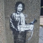 banksy-painted-charles-manson-as-a-hitchhiker-on-a-london-street-corner-in-2005.jpg