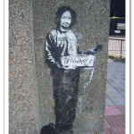 banksy-painted-charles-manson-as-a-hitchhiker-on-a-london-street-corner-in-2005.png